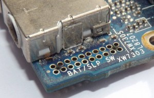 Closeup of the side of a Macbook audio jack shield